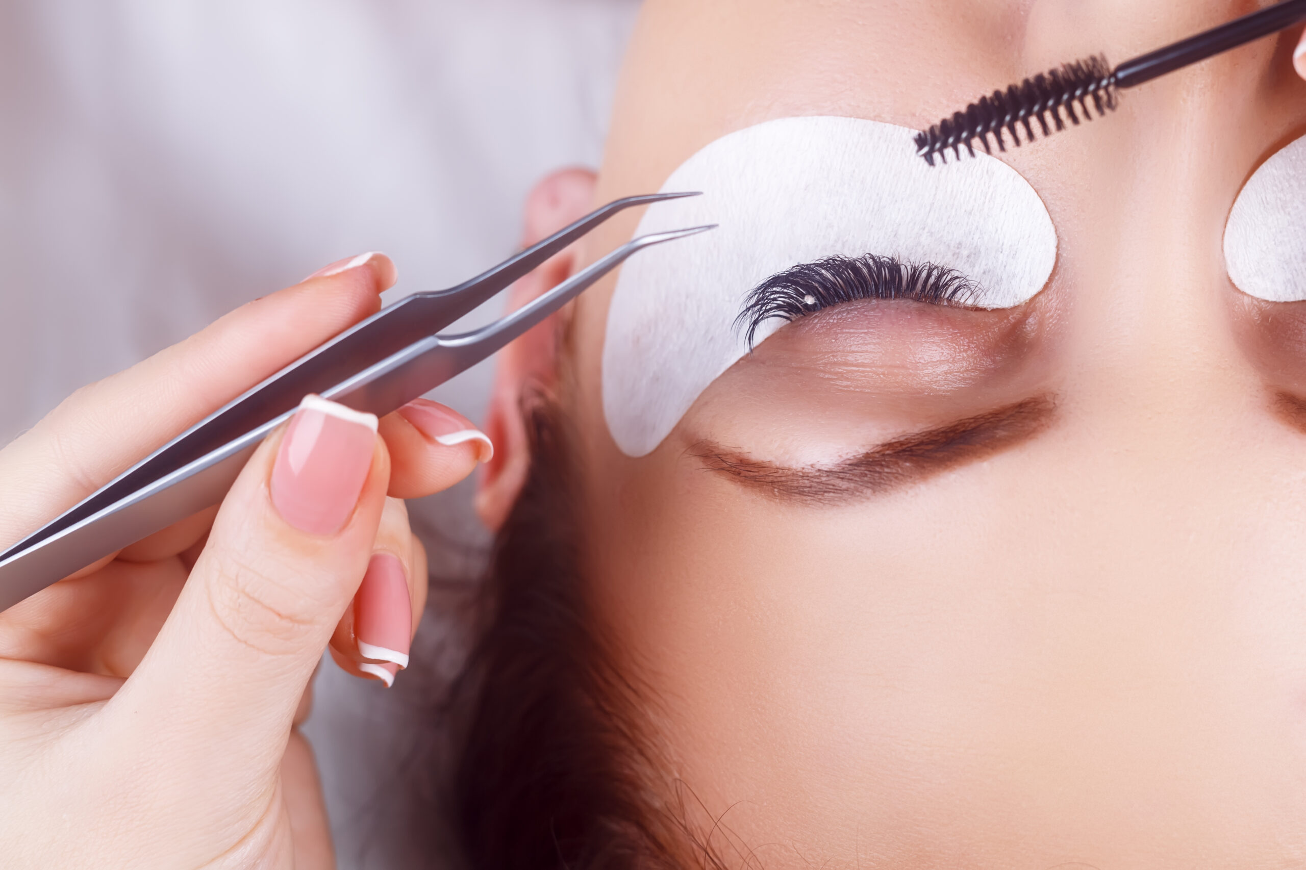 Eyelash Extension Procedure. Woman Eye with Long Eyelashes. Lashes. Close up, macro, selective focus