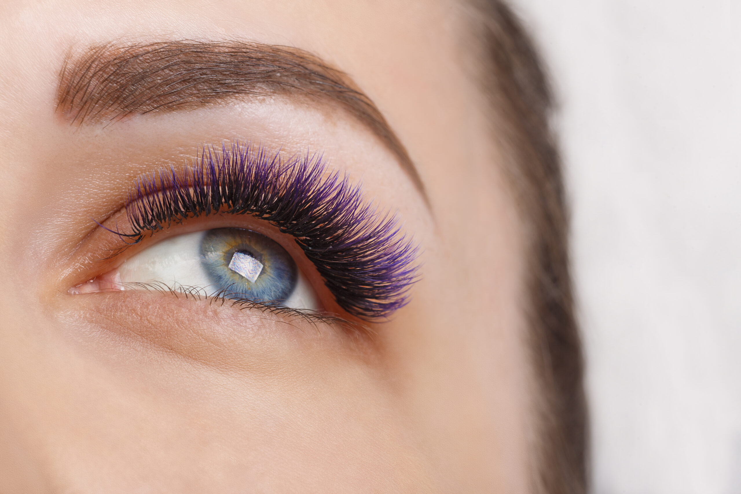 Eyelash Extension Procedure. Woman Eye with Long Eyelashes. Lashes. Close up, macro, selective focus